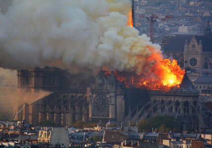 Smoke and flames rise during a fire at the landmark Notre-Dame Cathedral in central Paris on April 15, 2019, potentially involving renovation works being carried out at the site, the fire service said. - A major fire broke out at the landmark Notre-Dame Cathedral in central Paris sending flames and huge clouds of grey smoke billowing into the sky, the fire service said. The flames and smoke plumed from the spire and roof of the gothic cathedral, visited by millions of people a year, where renovations are currently underway. (Photo by Hubert Hitier / AFP)